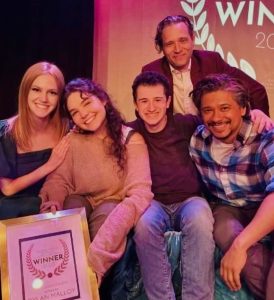 A photo of Dylan Malloy with her cast from the Blank Theatre's Young Playwrights Festival