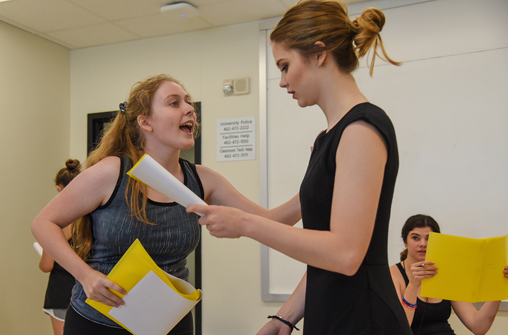 Two student actors rehearse a scene.