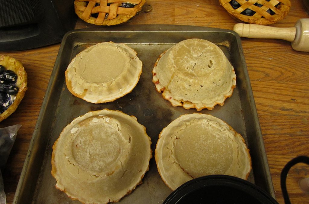 To dry the bottom of the pies, place the pie pan upside down and the crust on the outside of the pan so the dough holds its shape.