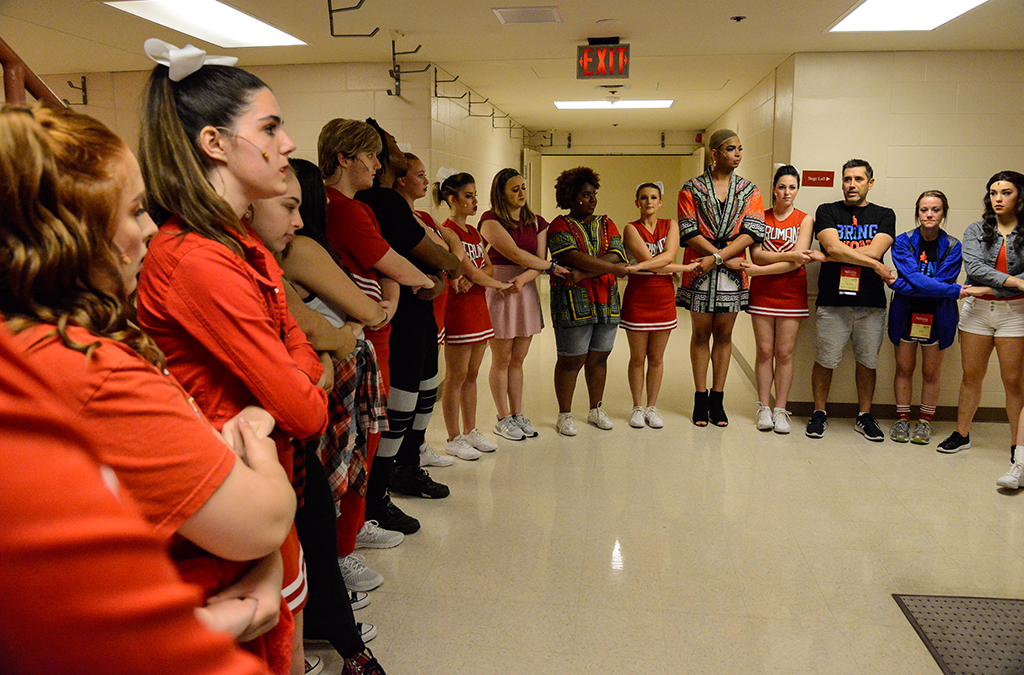 Kansas Thespians circle up one last time before hitting the stage in Bring It On.