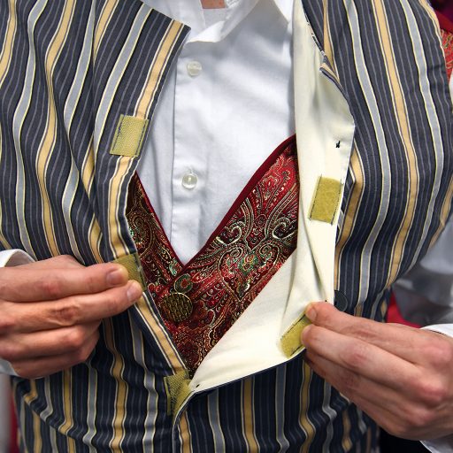 Underlayering costumes or costume elements can simplify and expedite quick changes. Changing a shirt or even just a vest can give an outfit an entirely new look, communicating a change in time or location to the audience. Color contrast is key. A muted, striped vest layered over a shiny, burgundy vest can be removed to transform an actor from servant to partygoer in seconds.