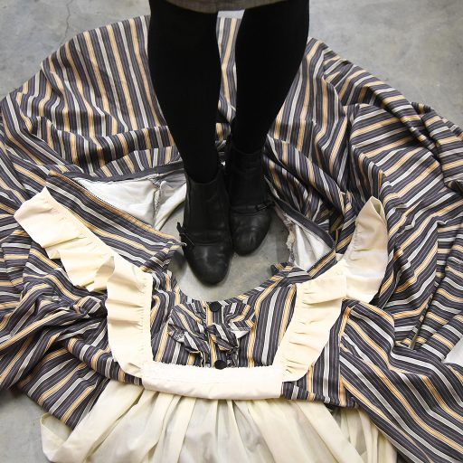 To get into a dress or skirt quickly, pool it on the floor before the show, leaving an opening wide enough to step into. During the quick change, simply step in and pull the garment up over your body. An actor can easily overhaul their costume while dressers focus on details such as shoes, wigs, gloves, etc.