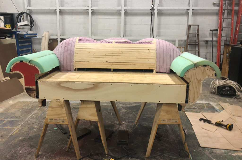 The foundation of the couch is padded before adding upholstery.