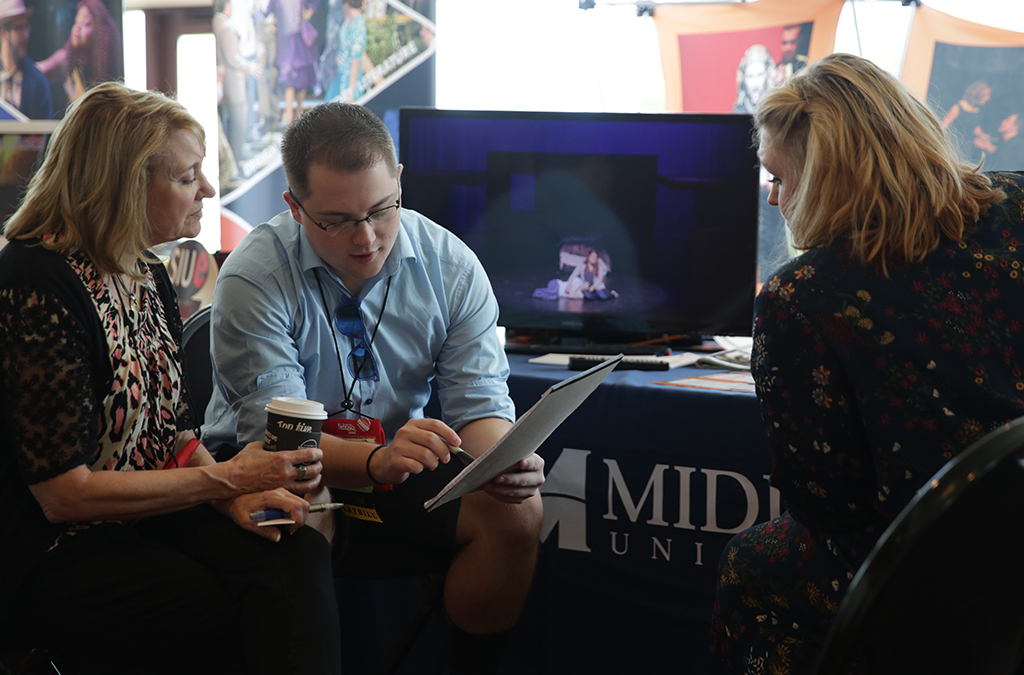 A student meets with college representatives at the 2017 International Thespian Festival.