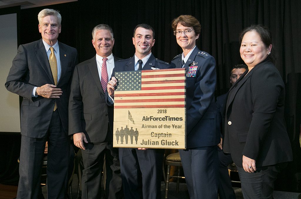 Senator Bill Cassidy, Congressman Drew Ferguson, Captain Julian Gluck, Lieutenant General Jacqueline Van Ovost, and Editor Michelle Tan as Gluck receives his Airman of the Year Award on July 11, 2018.