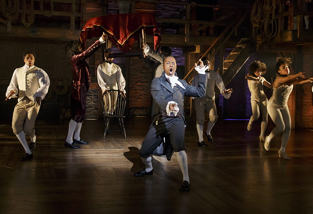 Leslie Odom Jr. (center) and the company of Hamilton.