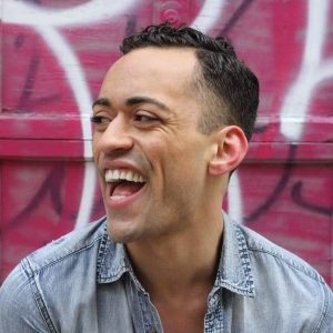 Black man looking to the side and laughing