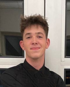 Jack Bachman black shirt against white doors
