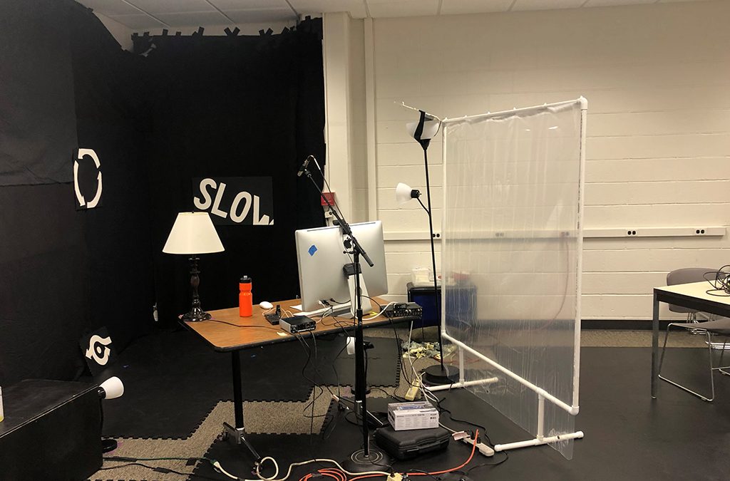 Table lamps, standing lights, and overhead fluorescents were combined in the lighting design for the Ball State University production of Overpass.