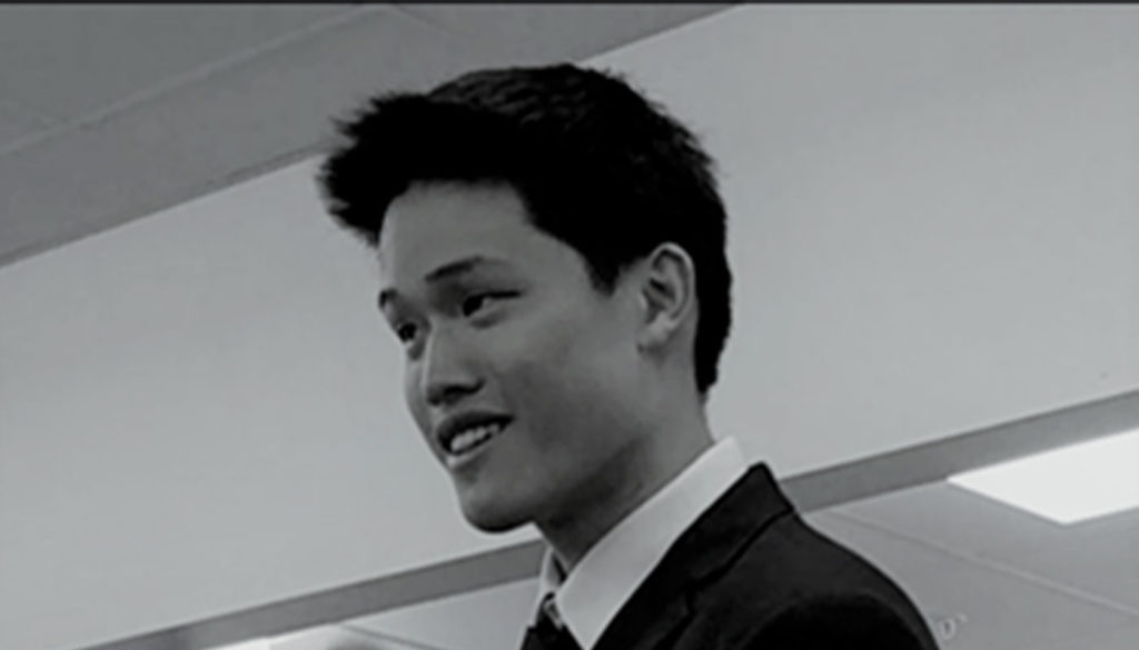 black and white photo of young man in a suit