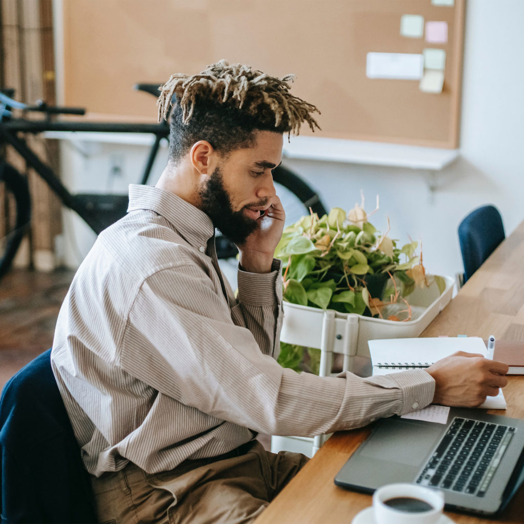 guy on computer and phone