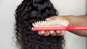 Black wavy hair wig with paddle brush shown